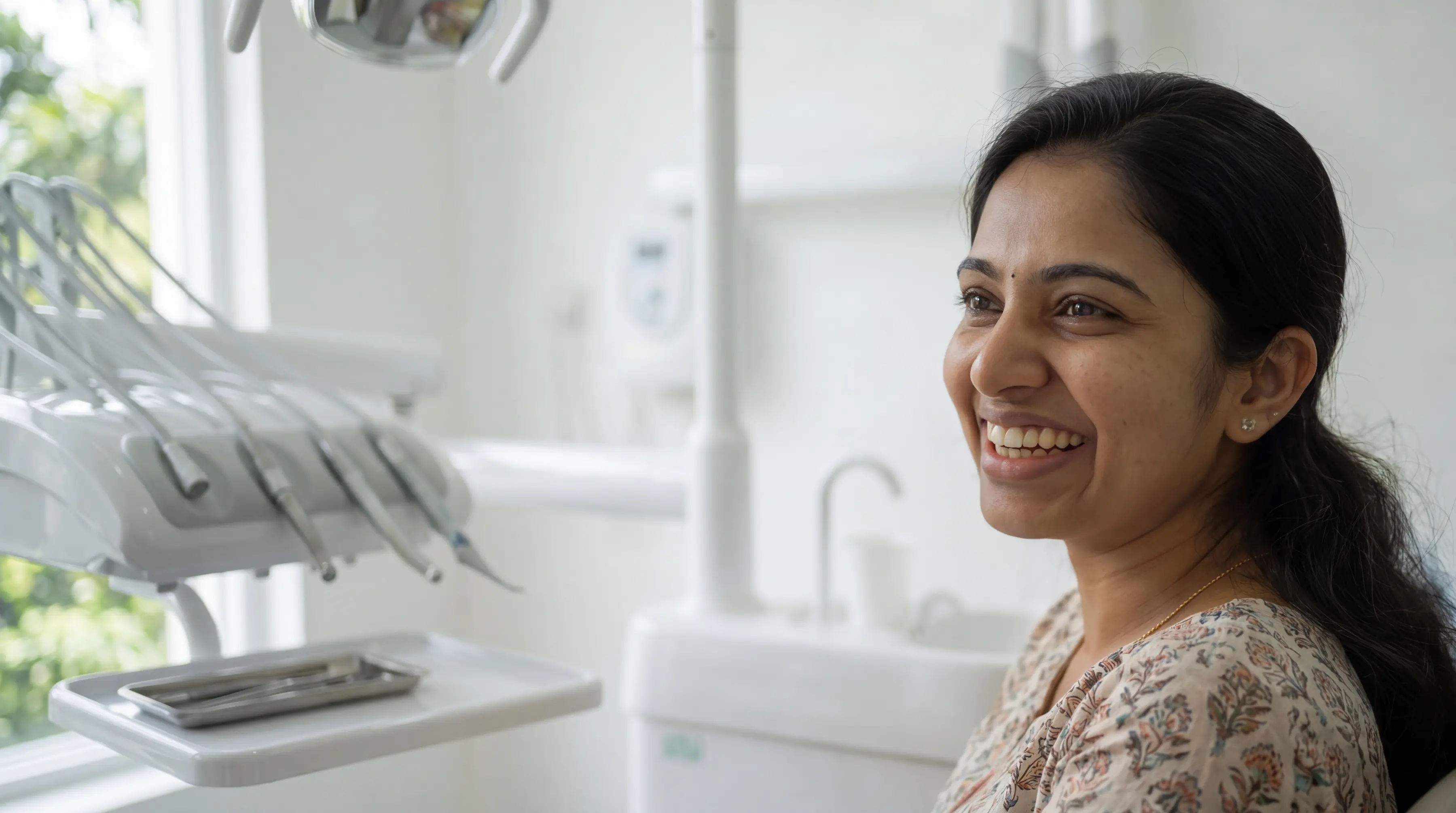 A smiling patient in a dental chair